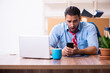 © Elnur - Young male employee in relocation concept