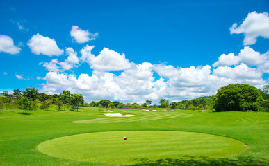 beautiful green view at golf course ,green trees and mountain blue sky white cloud background