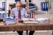 © Elnur - Old male employee unhappy with excessive work