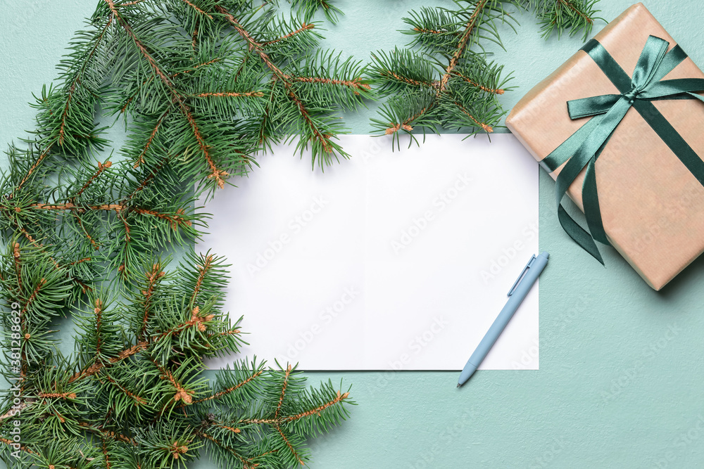 Beautiful Christmas gift with empty card on color background