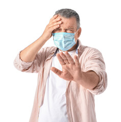 Poster - Stressed mature man in medical mask on white background