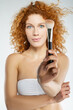 © Viacheslav Yakobchuk - Beautiful with blue eyes woman holding brush in hand isolated on white background