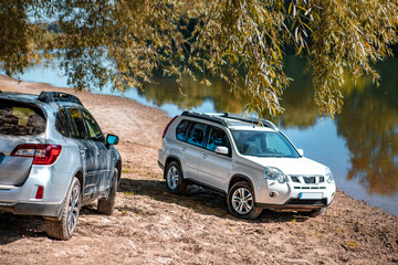 two cars parked at autumn river beach