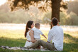 © Andriy Medvediuk - father, mother and son blow soap bubbles in the park together on a sunny summer day. happy family having fun outdoor