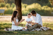 © Andriy Medvediuk - happy family mom dad and baby son happy in nature spending time together on summer sunny day. The concept of a fun holiday outdoors. Happy childhood.