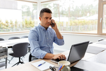 Sticker - remote job, technology and business concept - middle-aged man with laptop computer calling on smartphone at home office