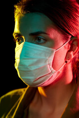 Wall Mural - health, safety and pandemic concept - close up of young woman wearing protective medical mask over black background