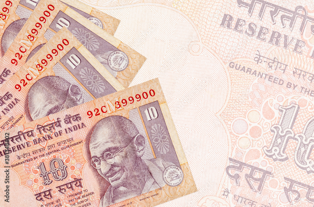 10 Indian rupees bills lies in stack on background of big semi ...