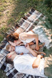 © Andriy Medvediuk - Mom, dad and little son lying on the blanket in the summer park. The concept of summer holiday. Mother's, father's, baby's day. Family spending time together on nature. Family look