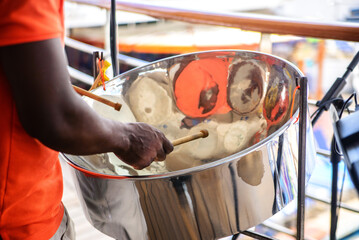 man is playing on a steel drums at cruise ship open deck