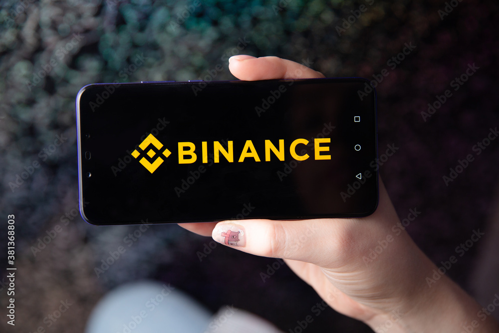 Tula, Russia - November 28, 2018: Apple iPhone and Binance logo and bitcoin, ethereum and dollars. is a cryptocurrency exchange.