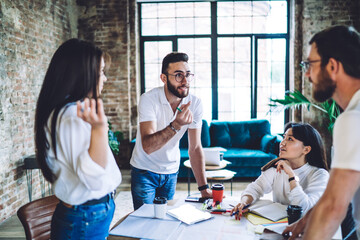 Confident man explaining information to colleague