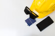 © Andre Nery - Solar Cell Energy concept image. Solar panel, safety helmet and work tools isolated on white. Text Space.