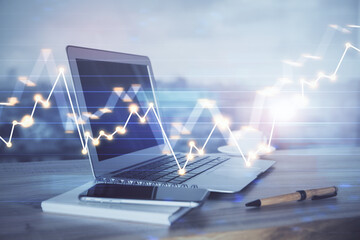 Forex Chart hologram on table with computer background. Multi exposure. Concept of financial markets.