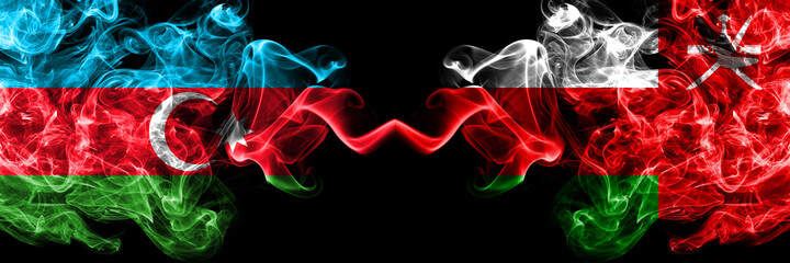 Azerbaijan, Azerbaijani vs Oman, Omani smoky mystic flags placed side by side. Thick colored silky abstract smoke flags