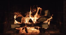 Slow Motion Of Fireplace Burning. Warm Cozy Fire In A Brick Fireplace Close Up. Cozy Winter Relax Background. Christmas Mood. Filmed In RAW 120fps 4k DCi.