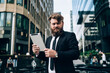 Confident bearded businessman with tablet