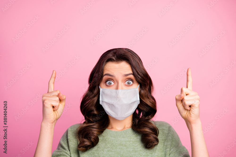 Portrait of astonished girl point index finger copyspace indicate covid infection quarantine news wear medical mask sweater pullover jumper isolated over pastel color background - obrazy, fototapety, plakaty 