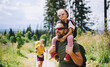 © Halfpoint - Family with small child hiking outdoors in summer nature.