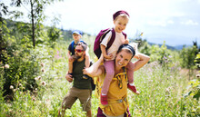 Family With Small Children Hiking Outdoors In Summer Nature.