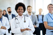© Drazen - Happy black female doctor attending an educational event in convention center.