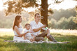 © Andriy Medvediuk - father, mother and son blow soap bubbles in the park together on a sunny summer day. happy family having fun outdoor