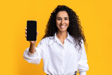Great App. Positive Brunette Woman Demonstrating Smartphone With Blank Black Screen