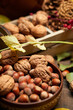 © soleg - autumn still life in rustic style as a background - leaves, vegetables and fruits, nuts and other natural food ingredients on wooden boards