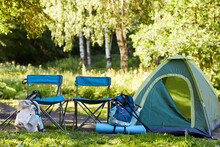 Background Image Of Empty Tent And Camping Gear On Camping Site In Forest, Copy Space