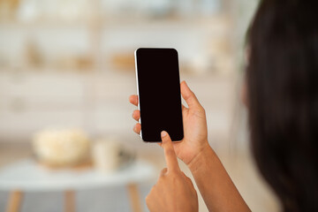 african american woman touching mobile phone screen with mockup for mobile app or website design, in