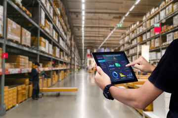 Smart warehouse management system.Worker hands holding tablet on blurred warehouse as background