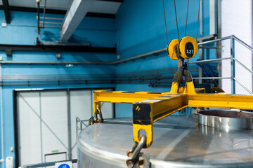 cable crane lifting a vat in a wine cellar