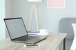 © White bear studio  - Workplace with modern laptop in the interior of the room