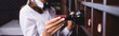 © LIGHTFIELD STUDIOS - Horizontal crop of sommelier taking bottle of wine from wooden rack