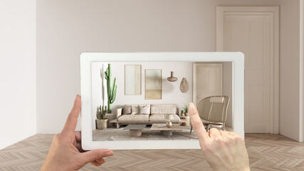 Wall Mural - augmented reality concept. hand holding tablet with ar application used to simulate furniture and de