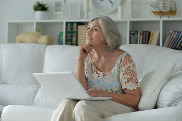 Canvas Print - Portrait of beautiful senior woman with laptop