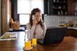 © lordn - Young business woman working from home, sitting in front of laptop computer having meeting over internet. Woman freelance entrepreneur.