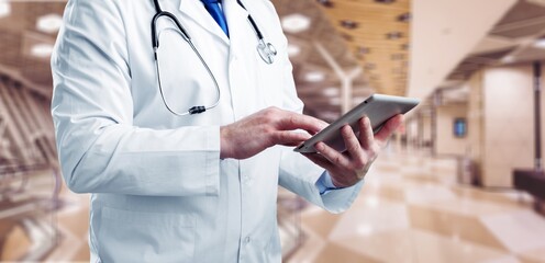 Wall Mural - Doctor in white coat holding a digital tablet