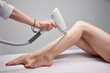 © Roman - young female on laser epilation in salon, get hair removal by professional specialist beautician in salon, apply electric device on legs