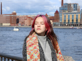 beautiful teenage girl enjoying sunny good weather in the city