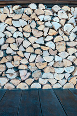 chopped birch firewood on a wooden floor as a natural background