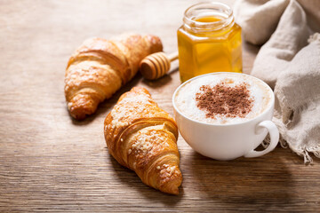 Wall Mural - cup of cappuccino coffee and croissants