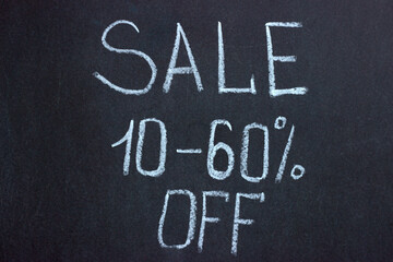 
The inscription on the chalk board SALE 10-60%. Commercial lettering
