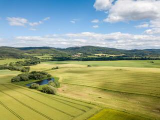 agricultural landscape with a small town in the background photographed from above