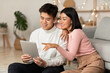 © Prostock-studio - Japanese Boyfriend And Girlfriend Using Digital Tablet Sitting At Home