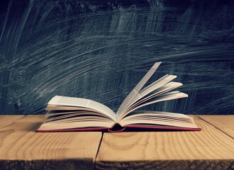 Wall Mural - open book on old wooden table