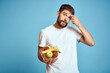 © SHOTPRIME STUDIO - dark background handsome man with a beard holding fresh fruit and lifestyle transparent cup