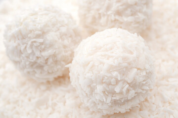 Valentine's day sweets, luxurious temptation and fancy treat concept with spherical coconuts and almonds confection isolated on white background made of coconut shavings