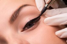 Permanent Eye Makeup Close Up Shot. Cosmetologist Applying Tattooing Of Eyes. Makeup Eyeliner Procedure