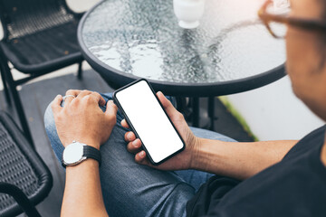 Wall Mural - cell phone mockup blank white screen.woman hand holding texting using mobile on desk at coffee shop.background empty space for advertise.work people contact marketing business,technology